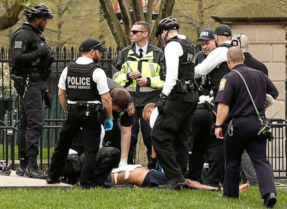 PHOTO: Police and rescue personnel remove a man on a stretcher from Lafayette Park after the man lit his jacket on fire in front of the White House in Washington, April 12, 2019.