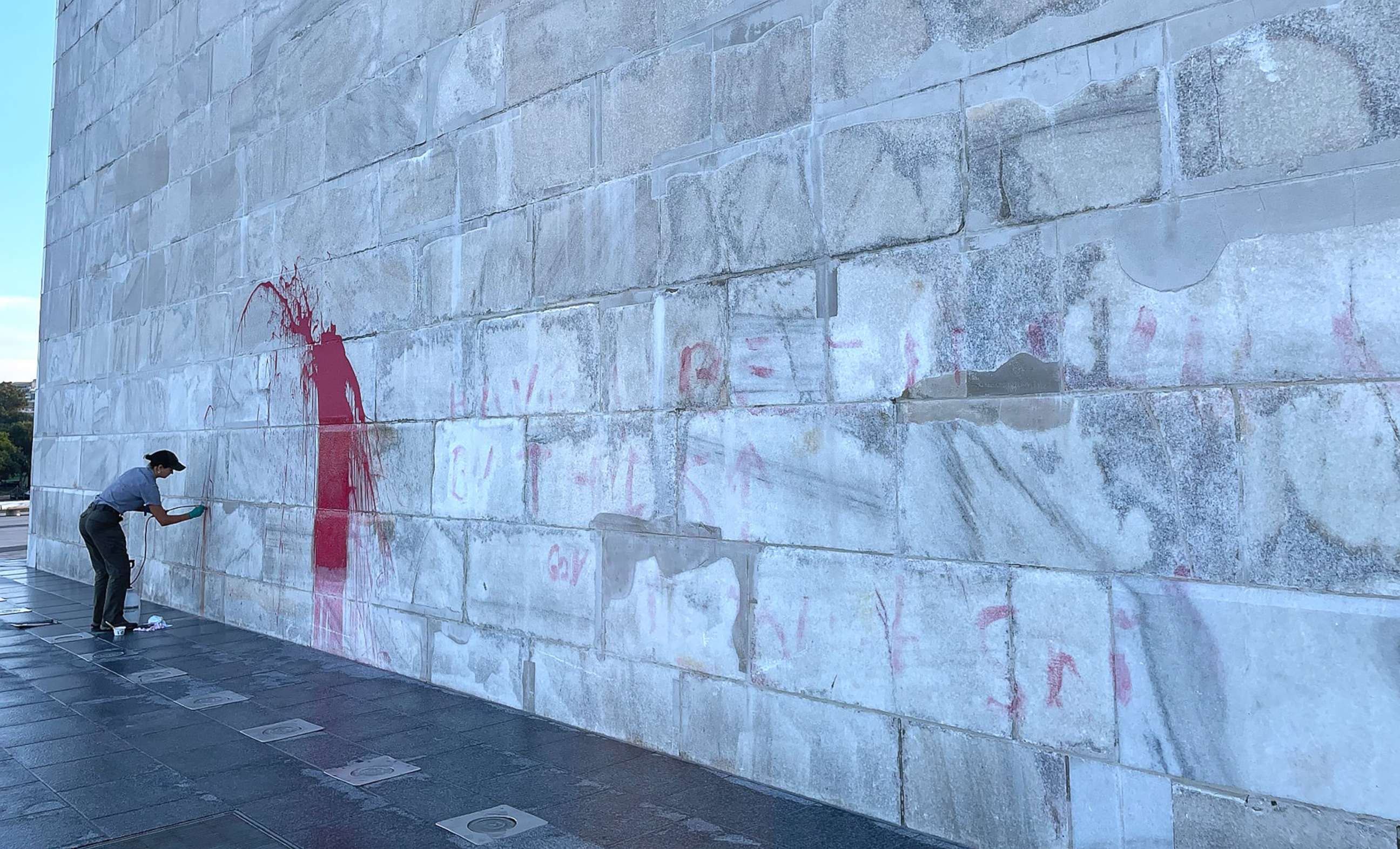 PHOTO: A Monument preservation crew member cleans red paint off the Washington Monument after it was defaced, Sept. 20, 2022, in Washington.