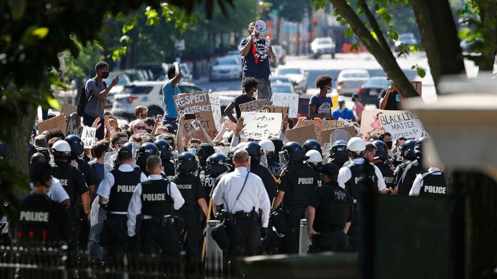 PHOTO: Protesters gather in front of a line of uniformed U.S. Secret Service as demonstrators gather to protest the death of George Floyd, near the White House, Saturday, May 30, 2020, in Washington. 