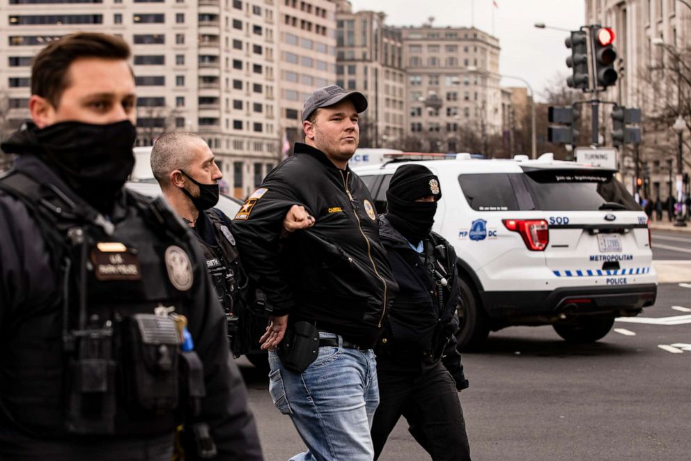 PHOTO: U.S. Park Police officers arrest a man after officers spotted him carrying a concealed firearm during a pro-Trump rally at Freedom Plaza on Jan. 5, 2021, in Washington, D.C.