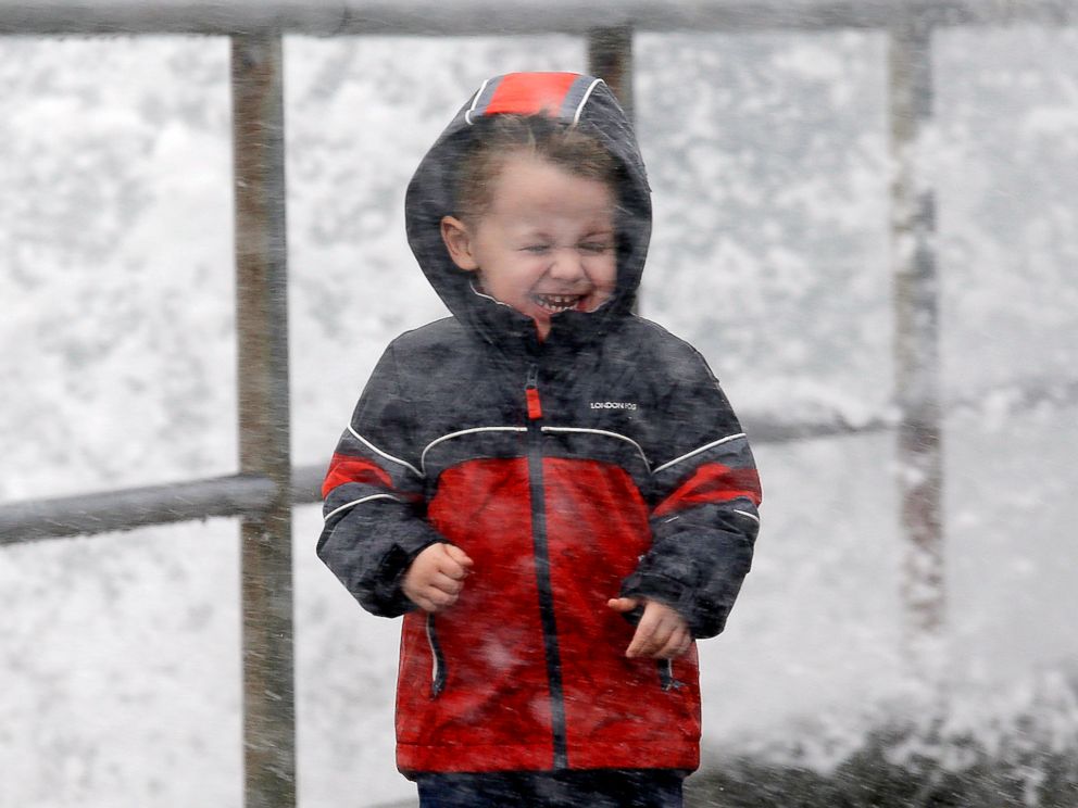PHOTO: Archer Christiansen, 3, braces himself against wind and a breaking wave as he walks with his parents in a windstorm along the Puget Sound, Nov. 13, 2017, in Seattle.