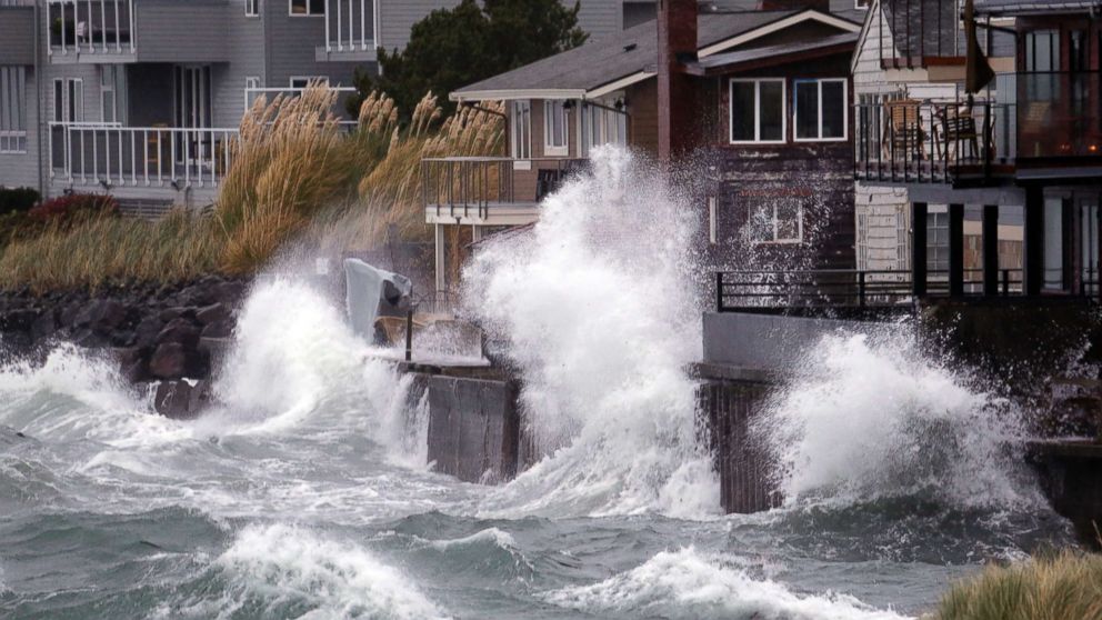 PHOTO: Waves send salt spray onto homes along Puget Sound in a windstorm, Nov. 13, 2017, in Seattle. 