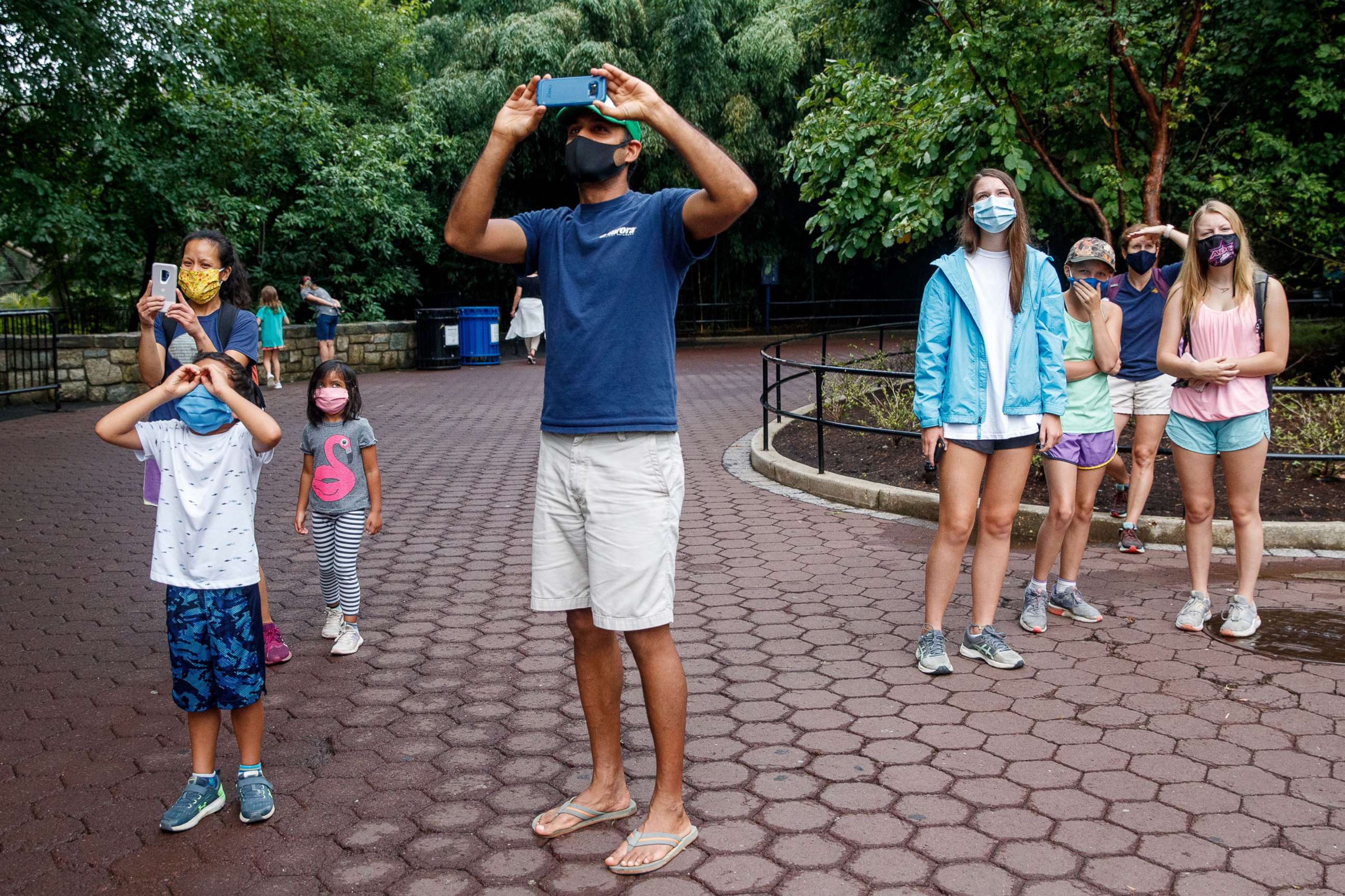 PHOTO: Zoo visitors look on as orangutans cross overhead at the Smithsonian's National Zoo in Washington, DC., July 24, 2020. The Smithsonian's National Zoo opens to the public following a temporary closure due to COVID-19.