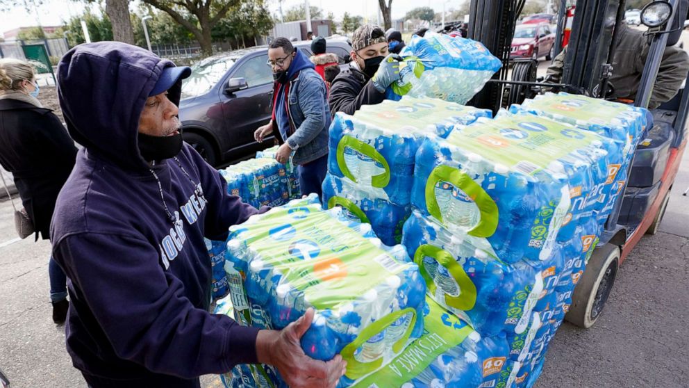 PHOTO: Donated water is distributed to residents, Feb. 18, 2021, in Houston, after a winter storm froze pipes and disrupted water treatment plants.
