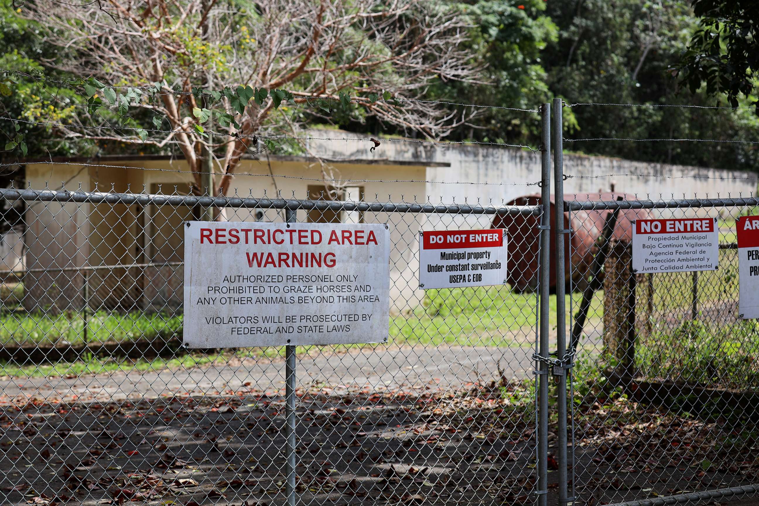 PHOTO: Warning signs are displayed on the fence surrounding the inactive Barceloneta Landfill site in Puerto Rico. About 300 tons of hazardous wastes are located in sinkholes on the property.