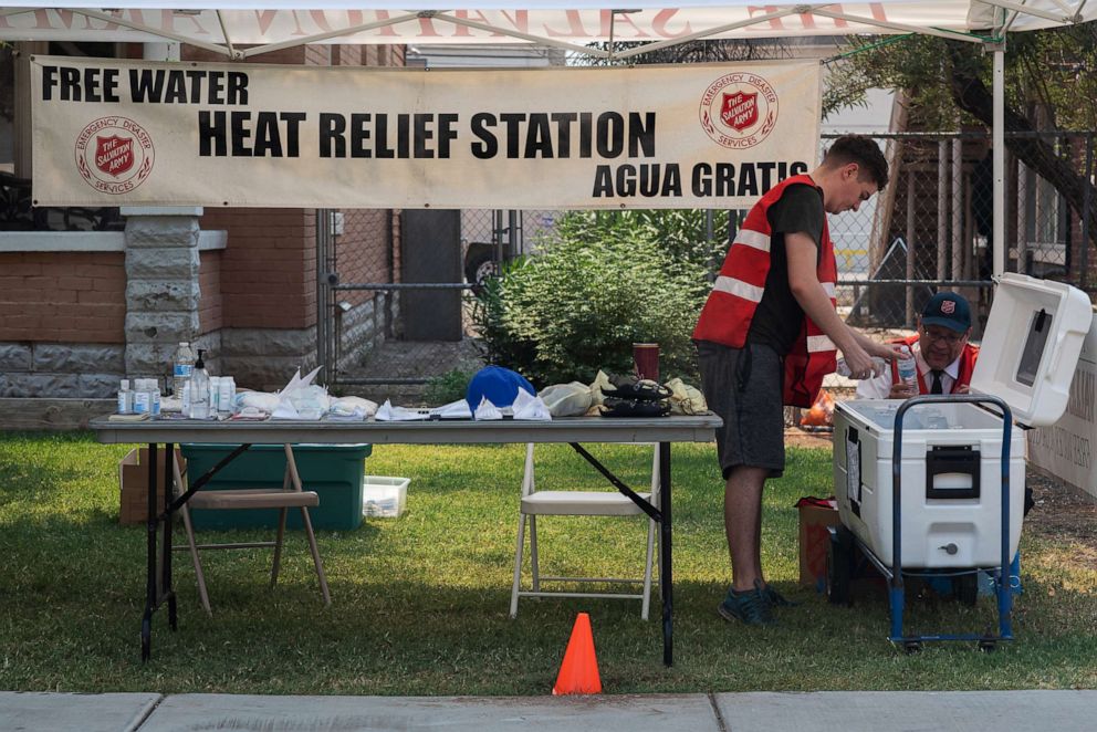 PHOTO: A volunteer fills a cooler with water at a heat relief station at the Salvation Army Phoenix Citadel on June 15, 2021 in Phoenix.