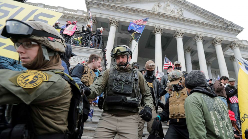 PHOTO: Jessica Marie Watkins, left, and Donovan Ray Crowl, center, both from Ohio, march down the East front steps of the U.S. Capitol with the Oath Keepers militia group in Washington, Jan. 6 2021.