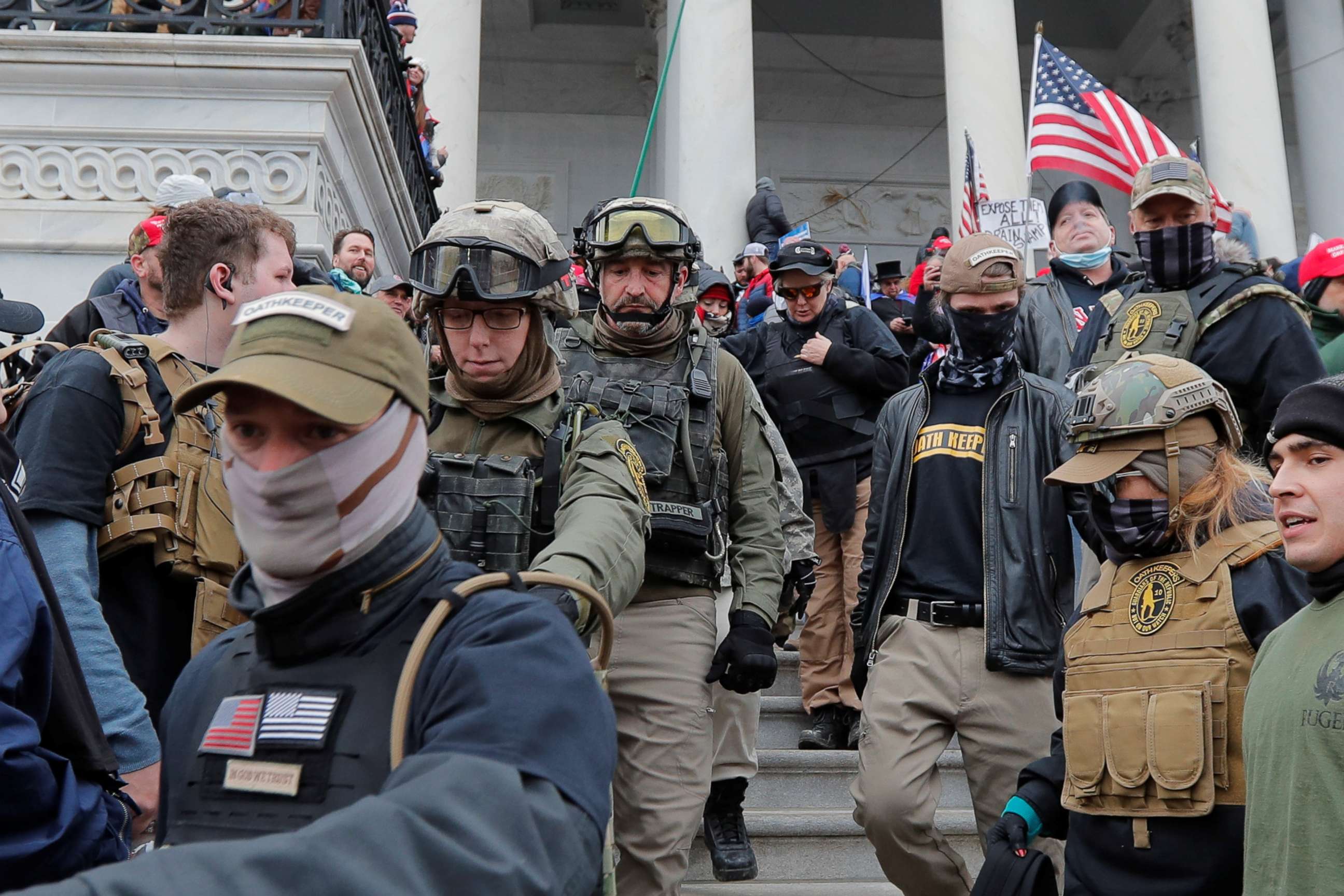 PHOTO: Jessica Marie Watkins, 2nd from left, and Donovan Ray Crowl, center, both from Ohio, march down the east front steps of the U.S. Capitol with members of the Oath Keepers militia group in Washington, Jan. 6, 2021.