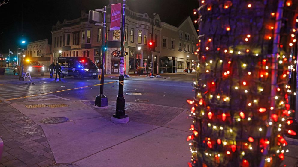PHOTO: Police tape cordons off a street in Waukesha, Wis., after a vehicle plowed into a Christmas parade, injuring at least 20 people and killing some, according to police, Nov. 21, 2021.