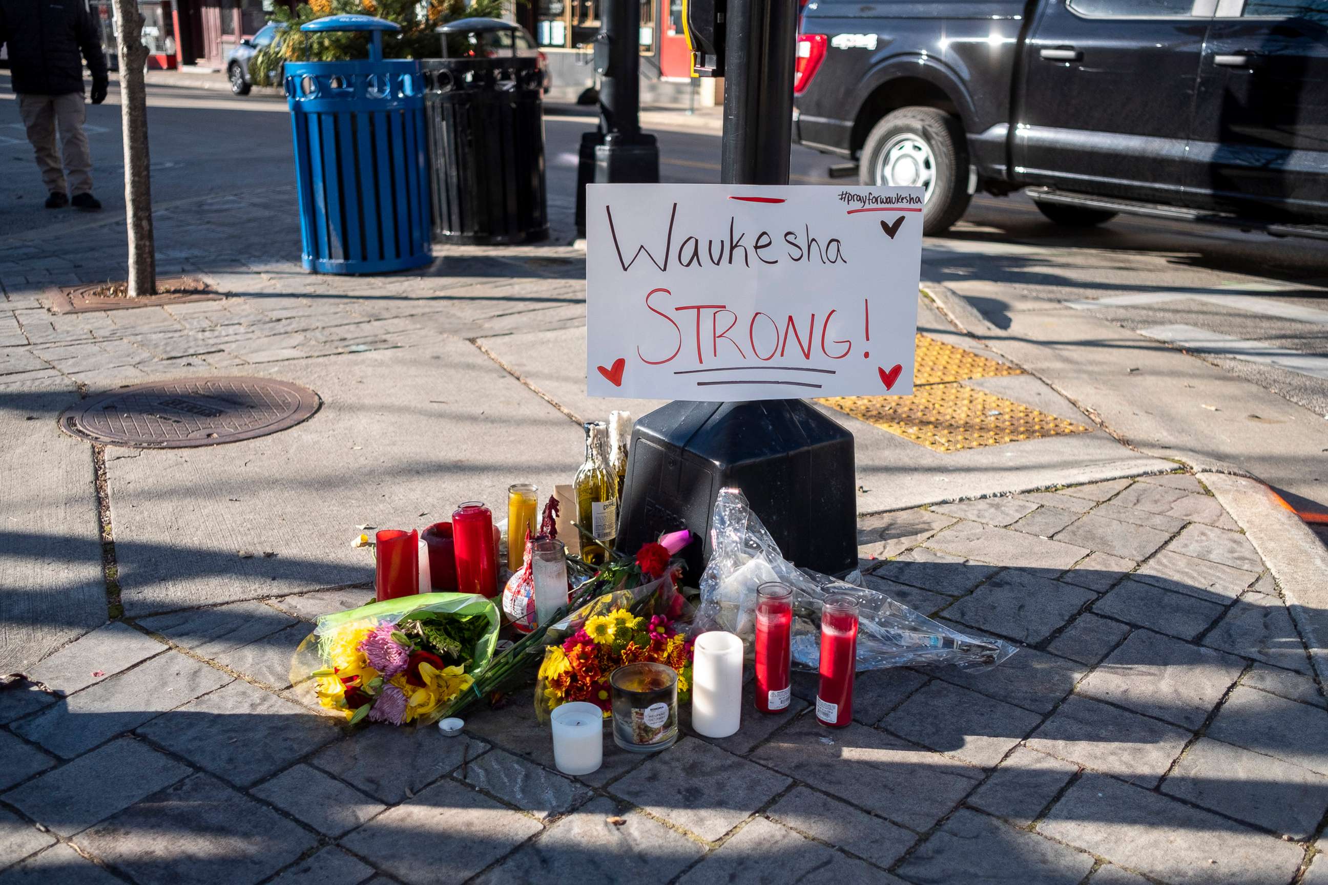 PHOTO: In this Nov. 22, 2021, file photo, memorials are left in areas where people were hit by a driver plowing into the Christmas parade on Main Street in Waukesha, Wis.