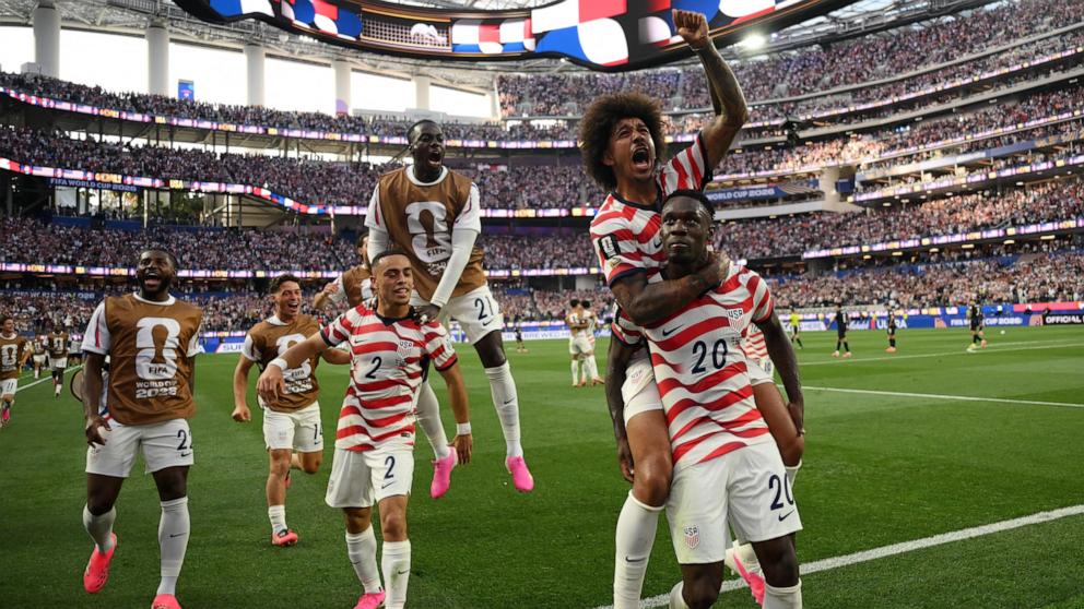 PHOTO: USA's Folarin Balogun celebrates with teammates after scoring his team's third goal during their FIFA World Cup 2026 Group D football match against Paraguay in Los Angeles, June 12, 2026. 