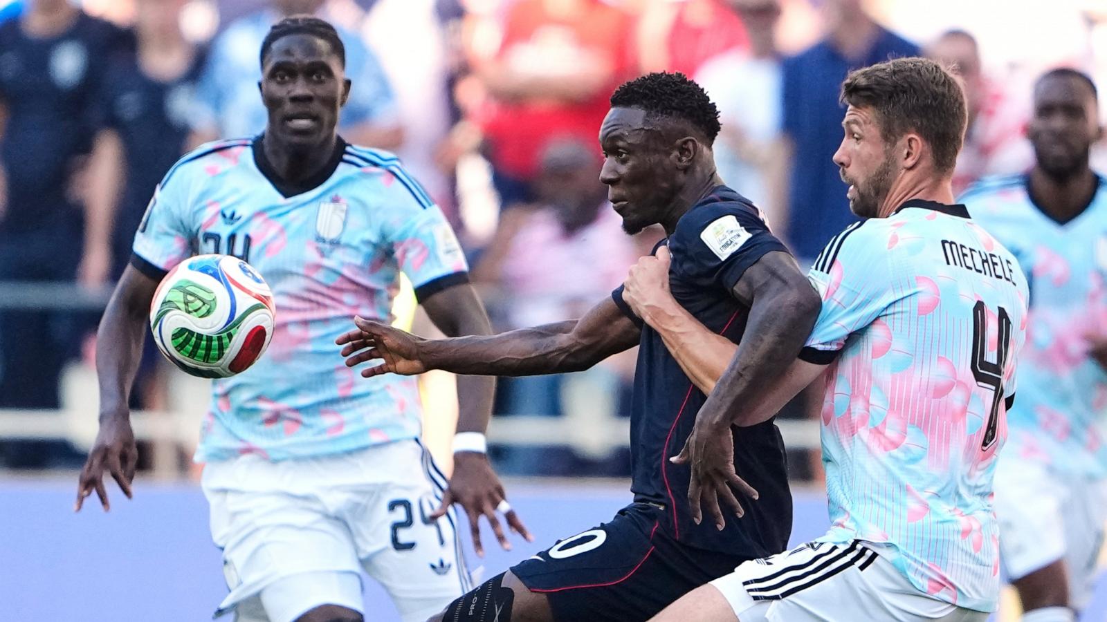 PHOTO: United States' Folarin Balogun battles for the ball with Belgium's Brandon Mechele during their World Cup round of 16 soccer match in Seattle, July 6, 2026.