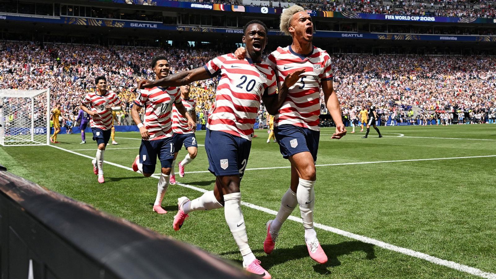 PHOTO: Folarin Balogun and Antonee Robinson of the USA celebrate after Australia's Cameron Burgess scores an own goal during their FIFA World Cup 2026 Group D match, June 19, 2026 in Seattle, Washington.