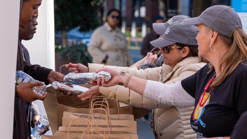 PHOTO: Workers with chef Jose Andres' World Central Kitchen distribute more than 1100 meals for federal workers and their families in Canal Park, Oct. 27, 2025, in Washington.