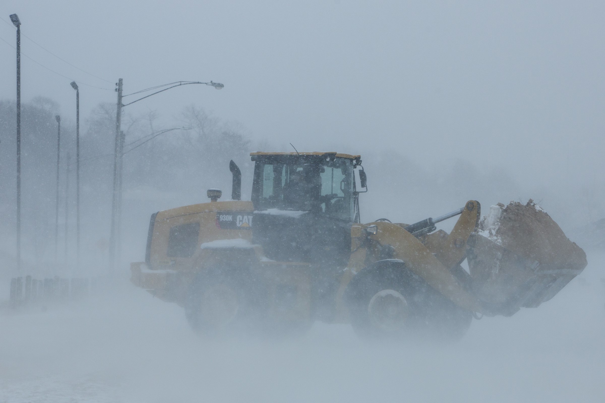 PHOTO: A loader moves sand from a parking lot back to Pere Marquette Beach in Muskegon, Mich., April 4, 2018. A spring storm dumped more than a foot of snow in parts of Michigan's northern Lower Peninsula.