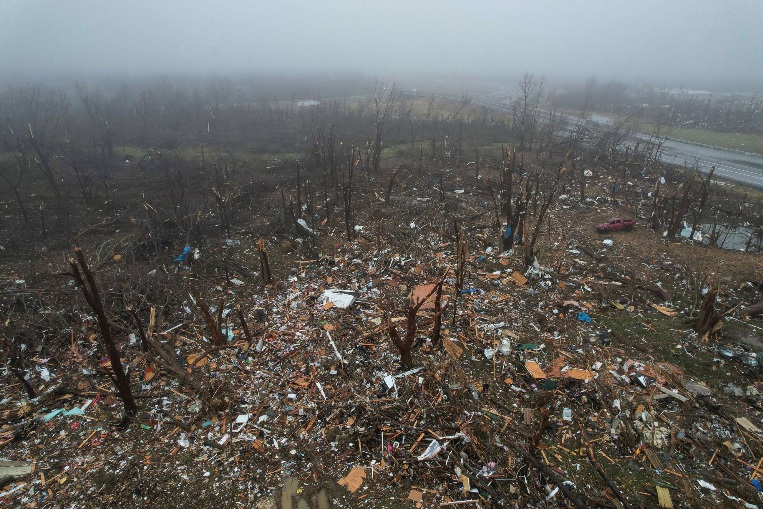 PHOTO: An aerial view of debris, including vehicles, which was swept into a forested area behind homes, following a devastating outbreak of tornadoes that ripped through several U.S. states, in Mayfield, Ky., Dec. 17, 2021.