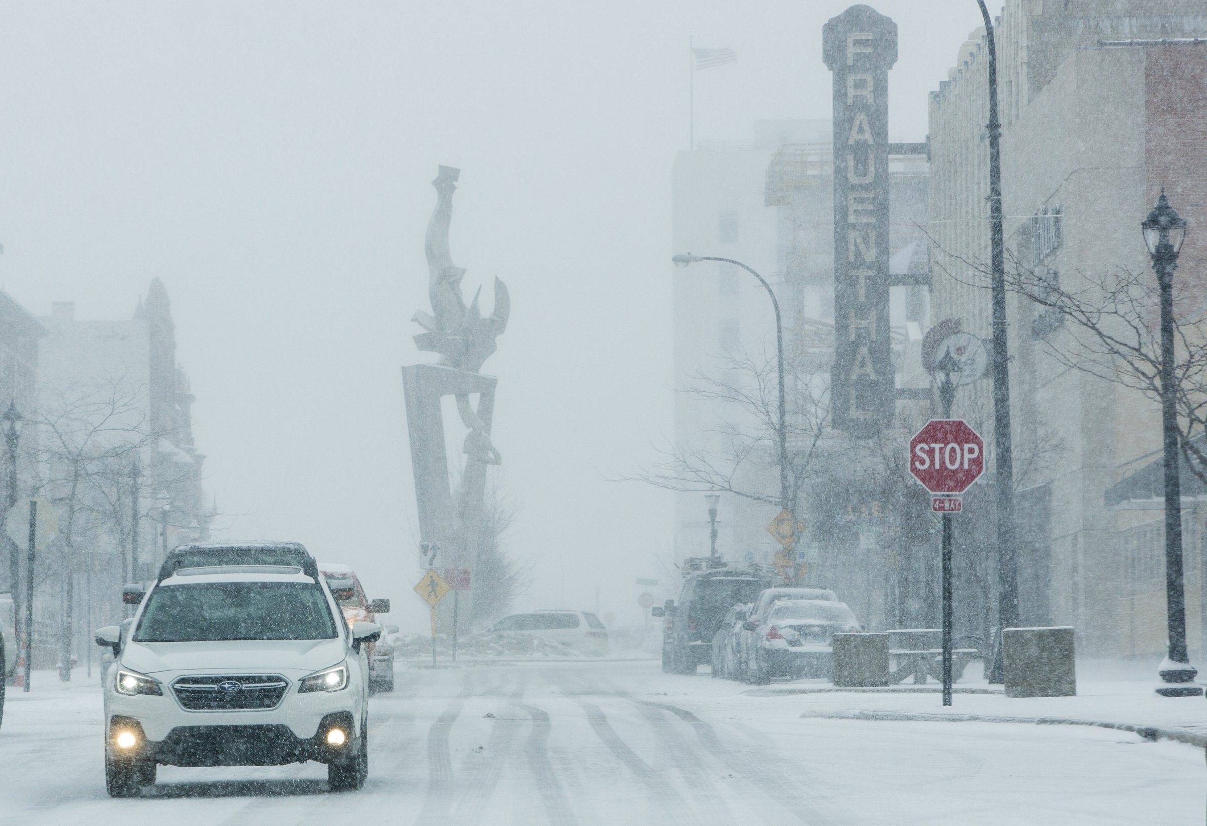 PHOTO: Vehicles drive through a snow storm in downtown Muskegon, Mich., April 4, 2018. A spring storm dumped more than a foot of snow in parts of Michigan's northern Lower Peninsula. 