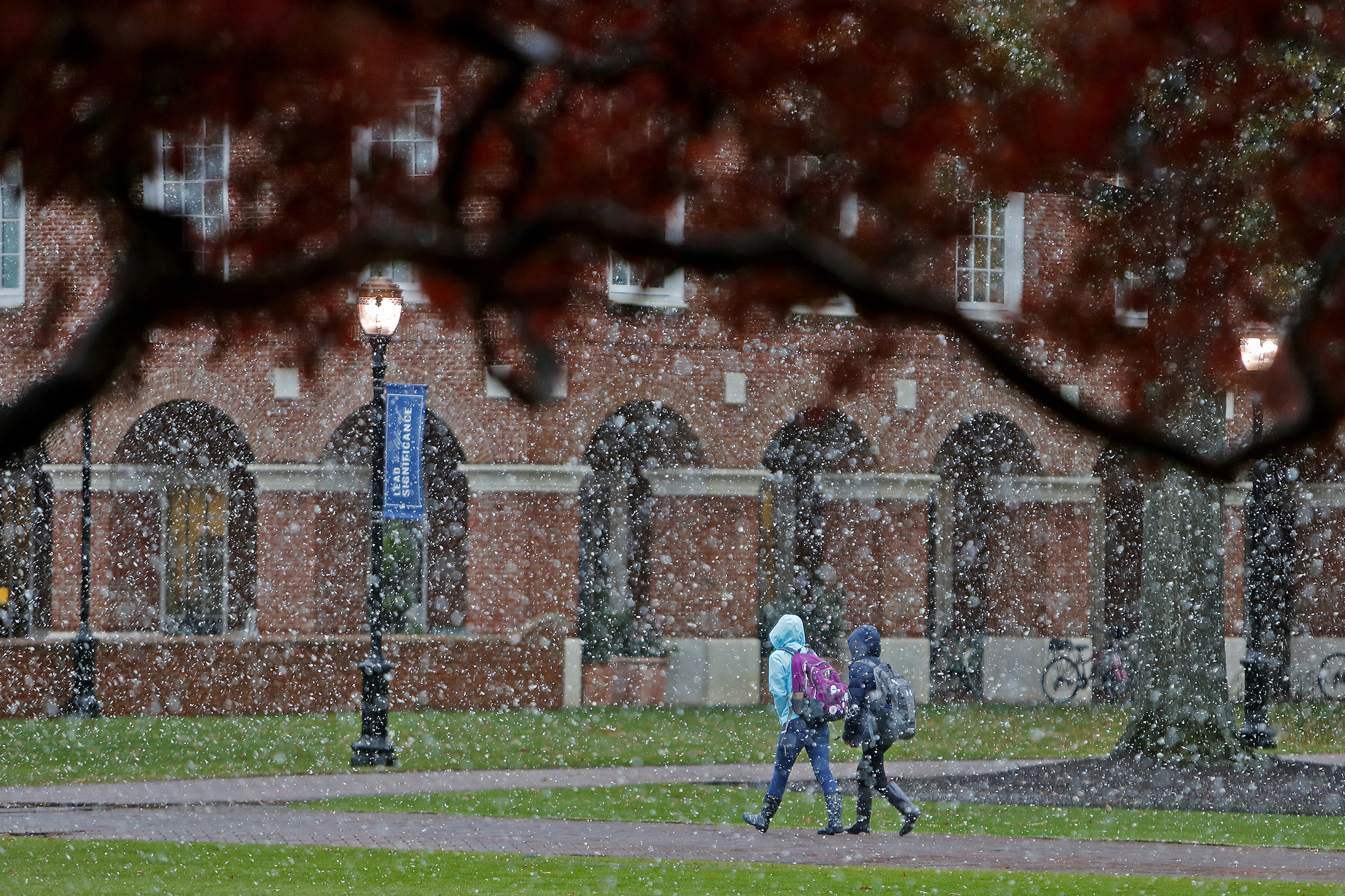 PHOTO: Christopher Newport University students make their way through campus as snow falls, Nov. 12, 2019 in Newport News, Va.