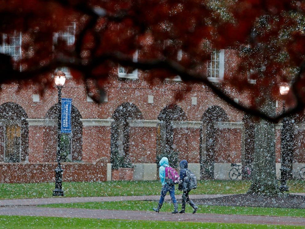 PHOTO: Christopher Newport University students make their way through campus as snow falls, Nov. 12, 2019 in Newport News, Va.