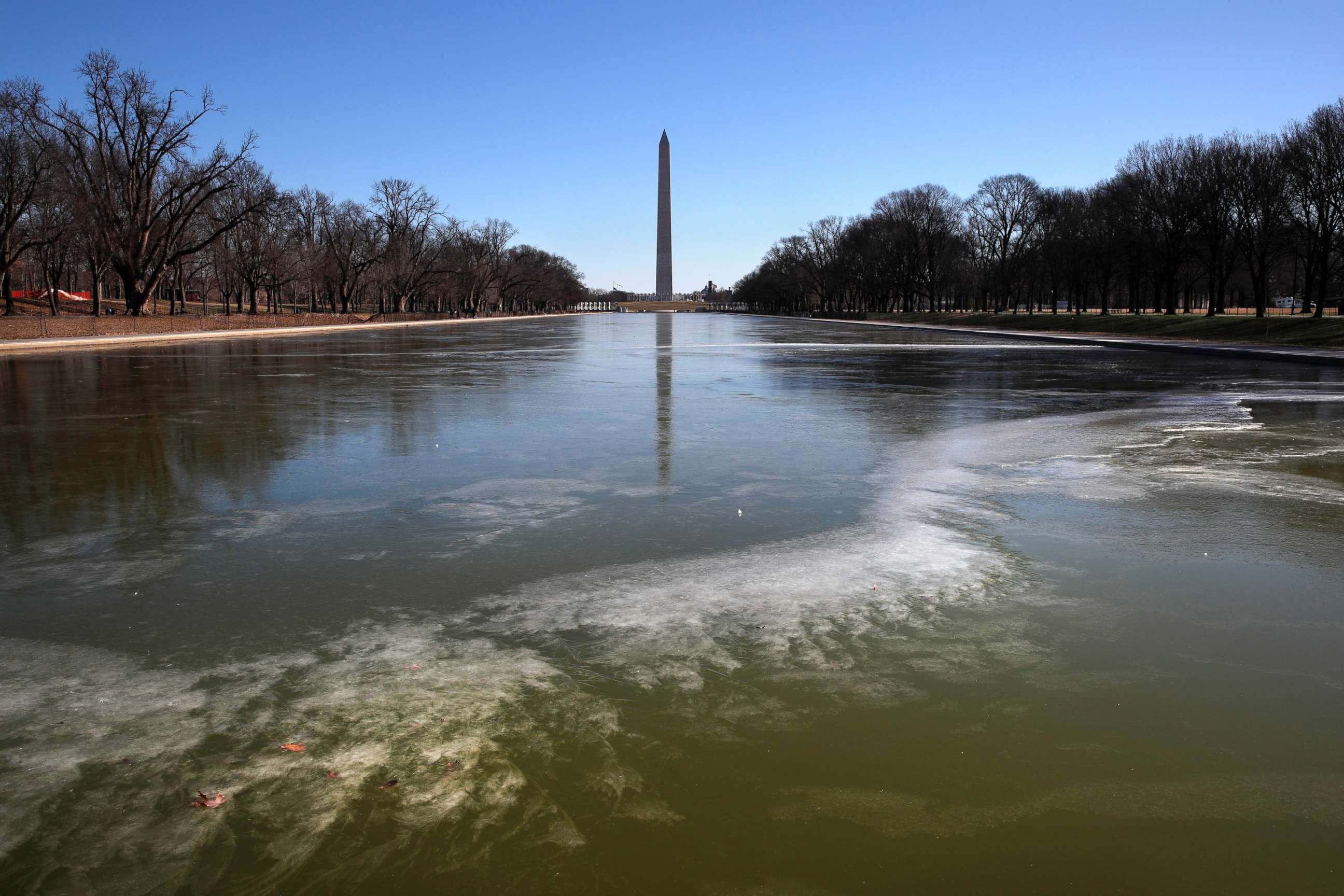 PHOTO: With the Washington Monument in the background, the reflecting pool by the Lincoln Memorial begins to turn to ice during frigid temperatures on the National Mall, Jan. 21, 2019, in Washington D.C.