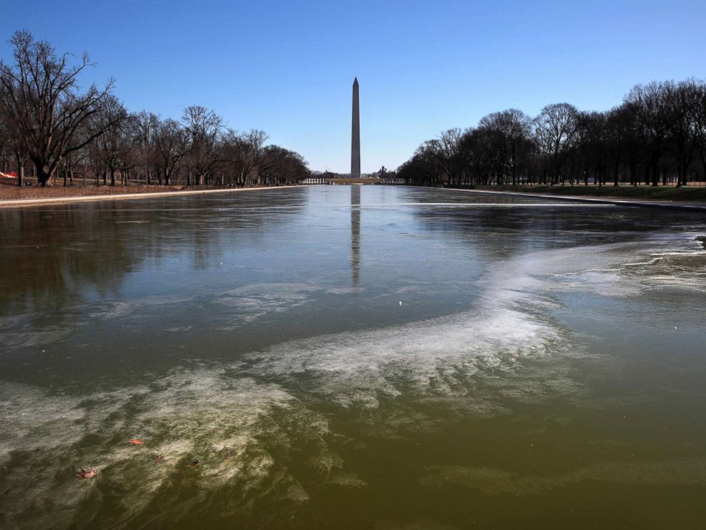 PHOTO: With the Washington Monument in the background, the reflecting pool by the Lincoln Memorial begins to turn to ice during frigid temperatures on the National Mall, Jan. 21, 2019, in Washington D.C.