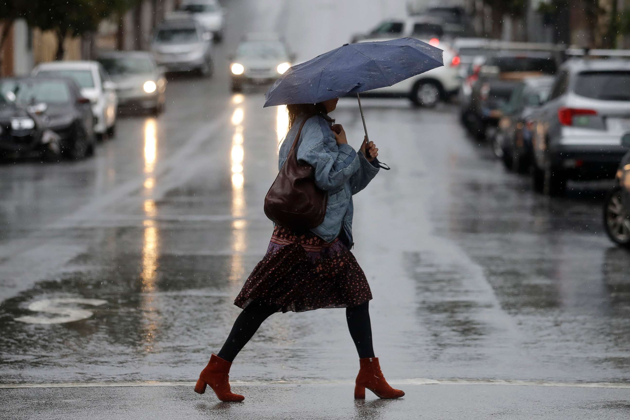 PHOTO: A woman carries an umbrella while walking in the rain in San Francisco, Nov. 26, 2019. 