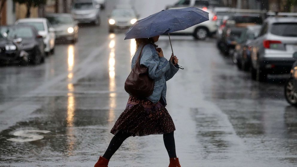 PHOTO: A woman carries an umbrella while walking in the rain in San Francisco, Nov. 26, 2019. 