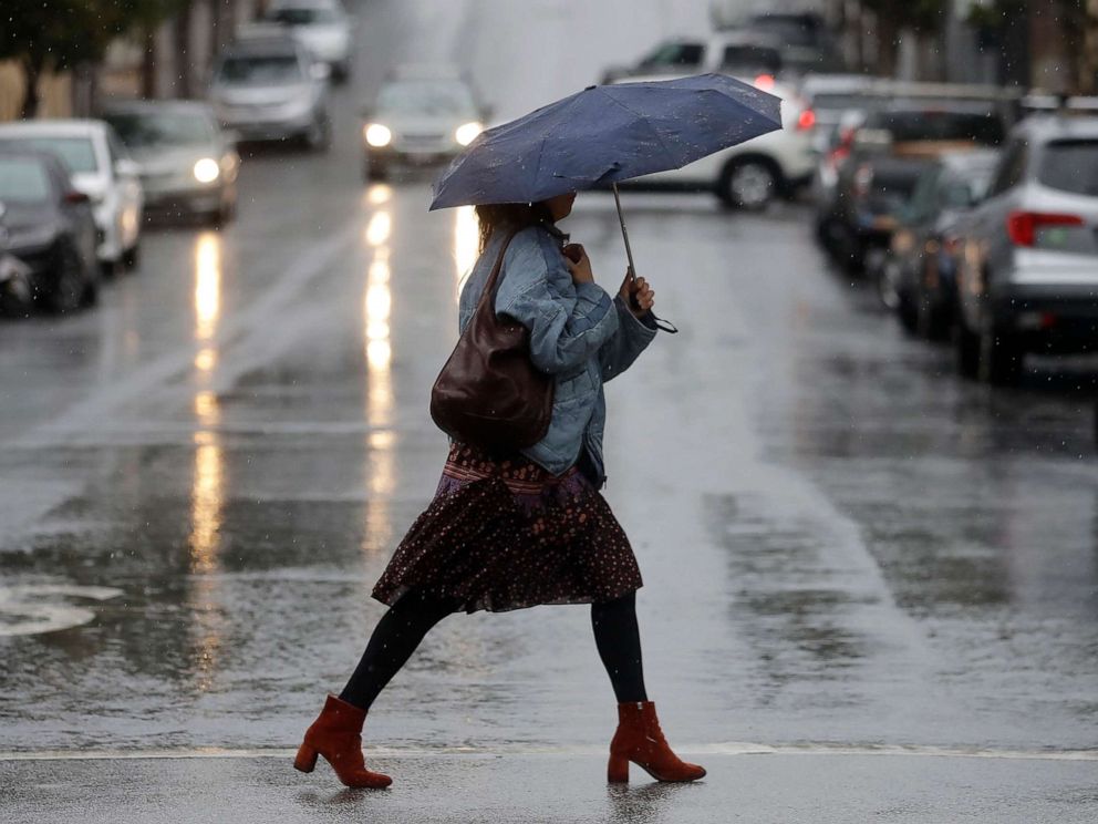 PHOTO: A woman carries an umbrella while walking in the rain in San Francisco, Nov. 26, 2019. 