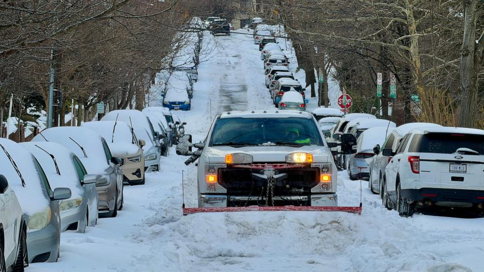 PHOTO: A truck plows snow on a residential street in Washongton, DC, on January 26, 2026.