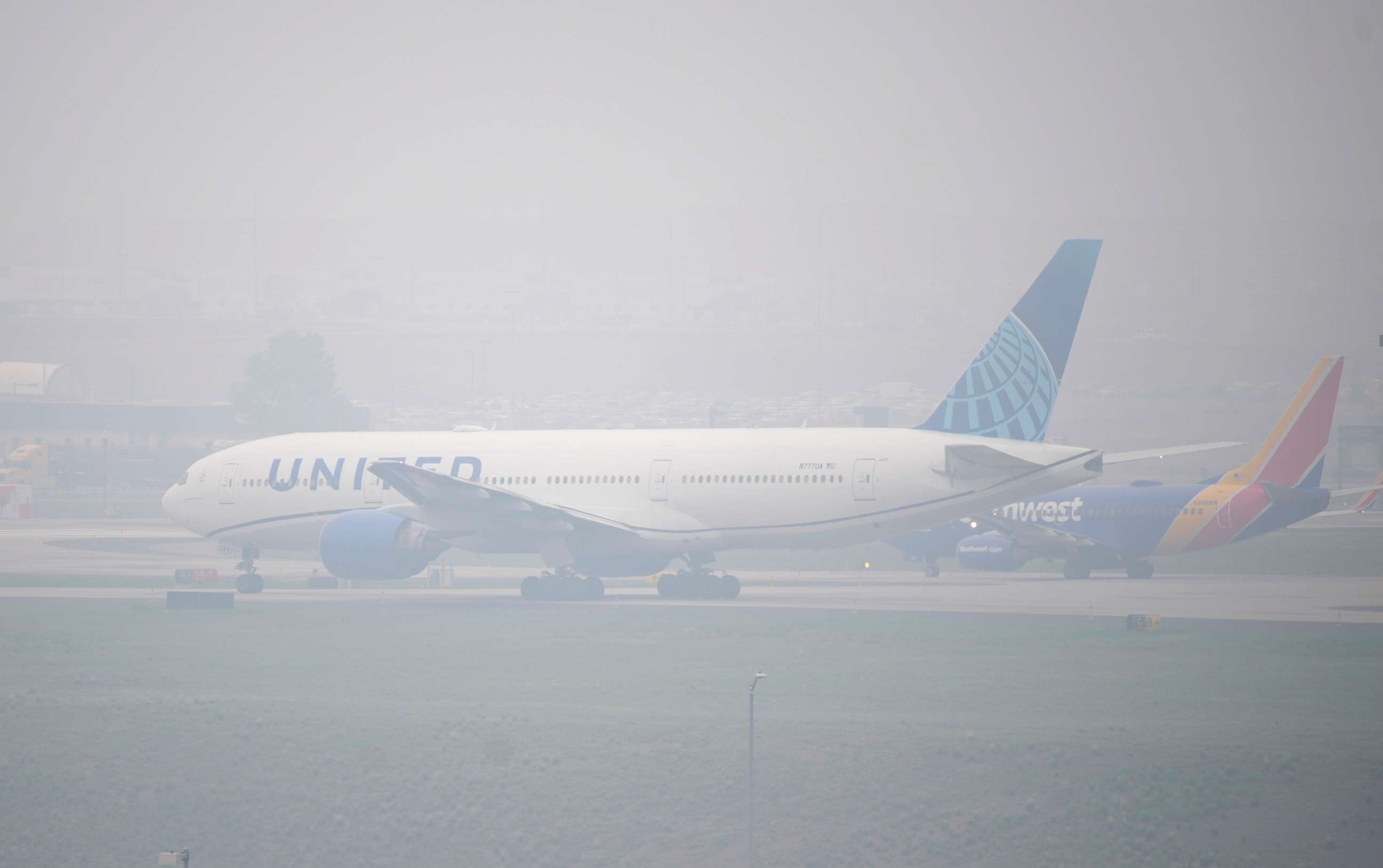 PHOTO: Jetliners taxi in heavy smoke at Denver International Airport, May 19, 2023, in Denver.