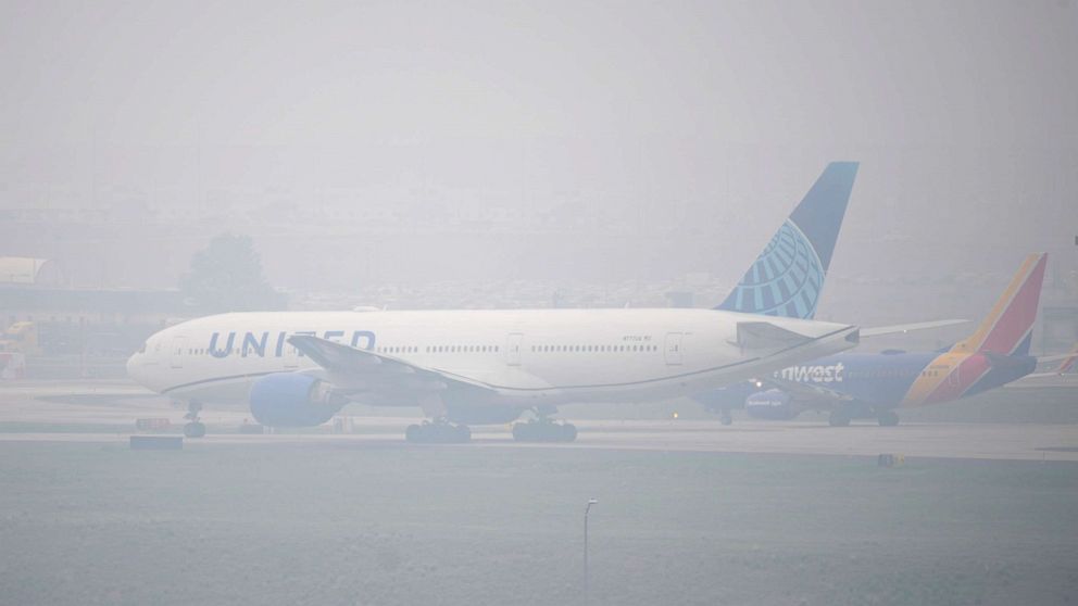 PHOTO: Jetliners taxi in heavy smoke at Denver International Airport, May 19, 2023, in Denver.