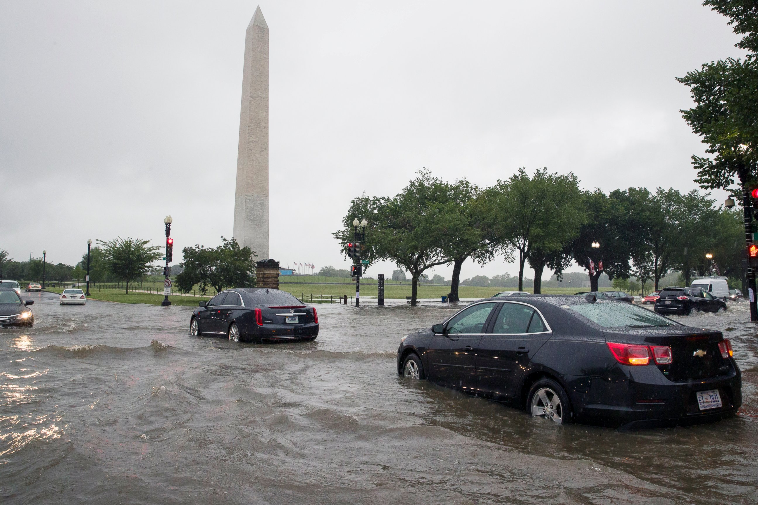 PHOTO: Heavy rainfall flooded the intersection of 15th Street and Constitution Ave., NW stalling cars in the street, Monday, July 8, 2019, in Washington near the Washington Monument.