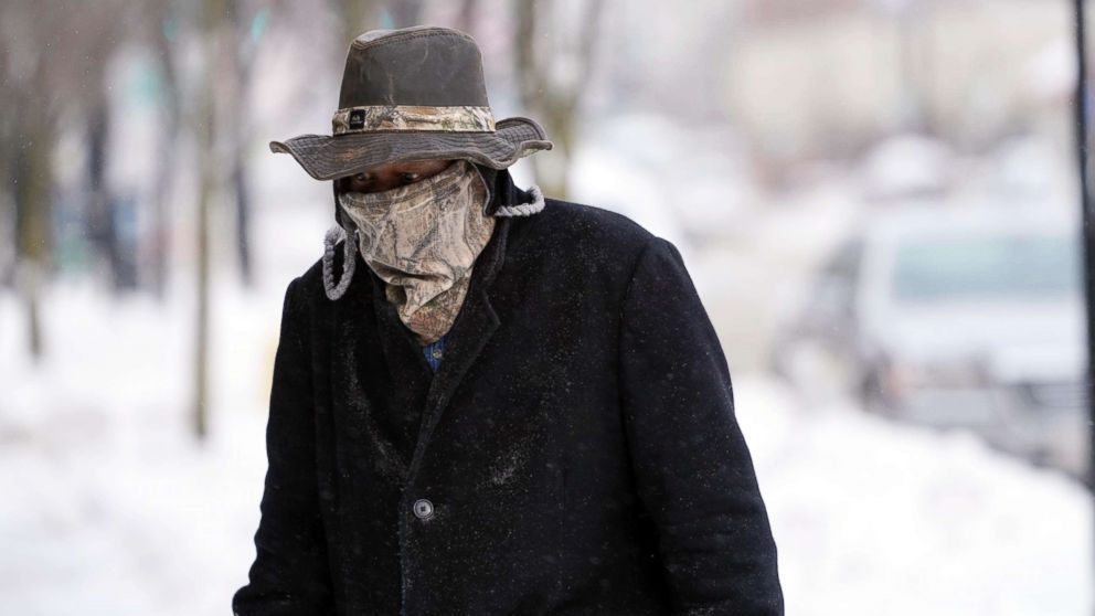 Marvin Hooks wears a face mask to protect him from the cold as he walks on North Street in Pittsfield, Mass., Jan. 21, 2019. Bitter cold and gusty winds swept across the eastern U.S. Monday with falling temperatures replacing the weekend's falling snow.