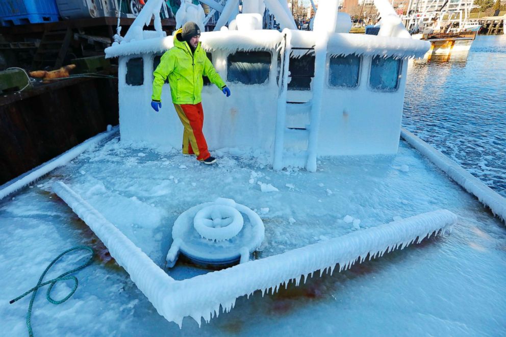 PHOTO: With temperatures in the single digits, Ray Levesque, mate of the crab/lobster boat Bradbill, makes his way across the ice-covered deck in New Bedford, Mass., Dec. 28, 2017. 