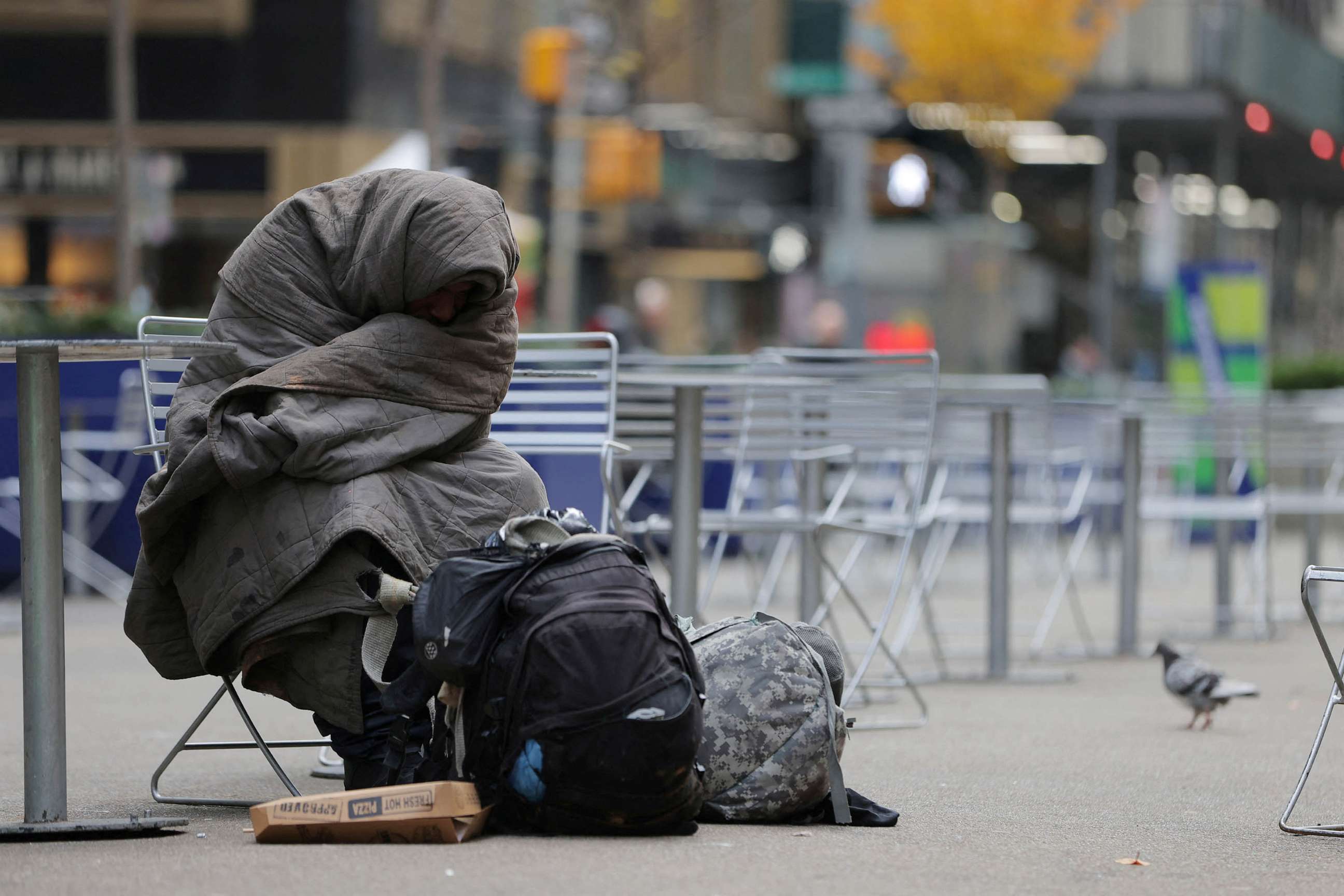 PHOTO: A person sits on Broadway in Manhattan, New York City, Dec. 1, 2022.