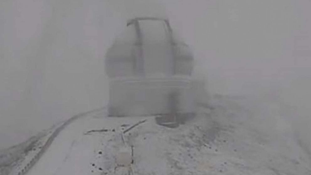 A snowstorm blew into Hawaii’s higher elevations, Nov. 27, 2017, as seen in this video grab of the observatories covered in snow on the Mauna Kea volanco.