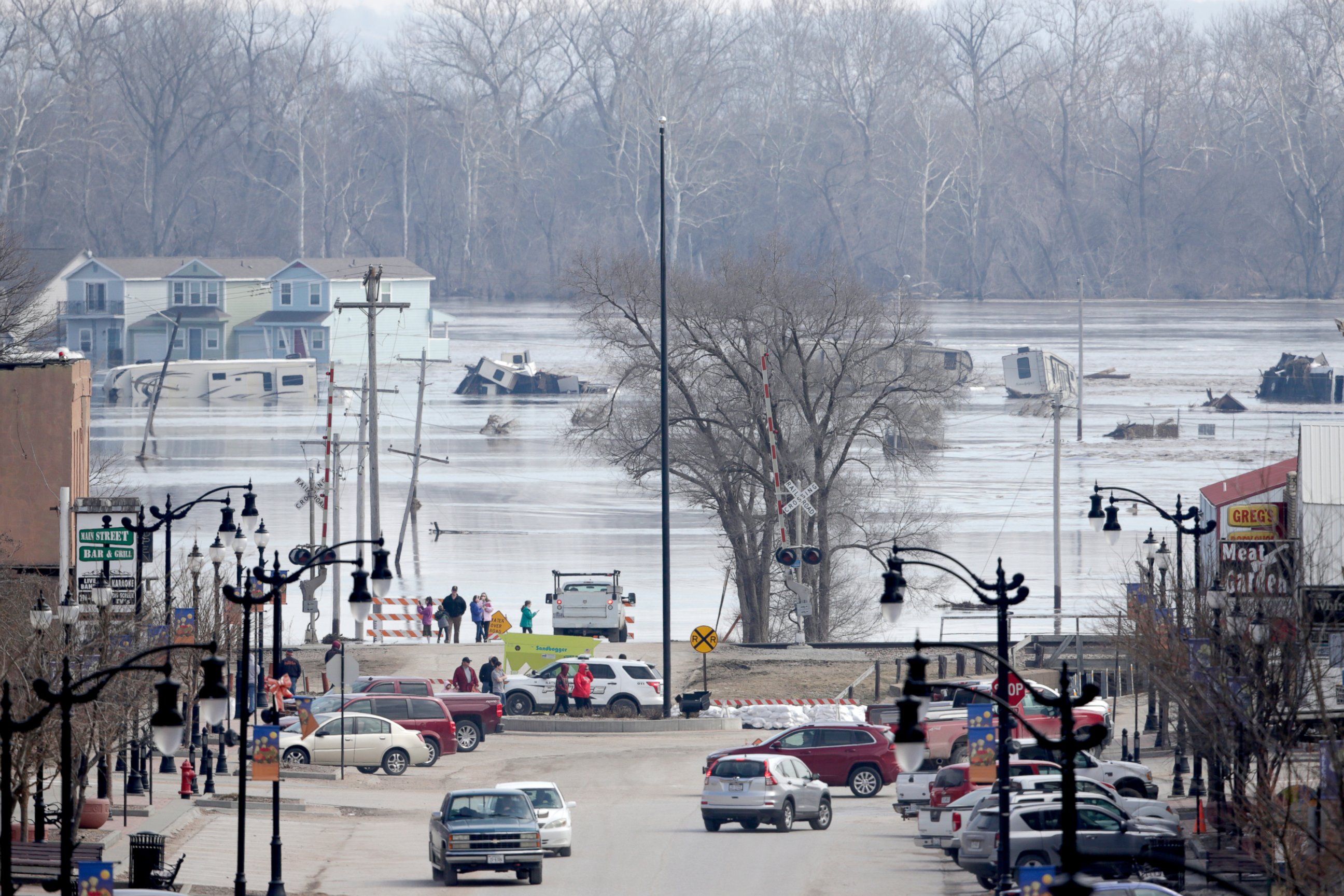 PHOTO: People view the rising waters from the Platte and Missouri rivers which flooded areas of Plattsmouth, Neb., Sunday, March 17, 2019.