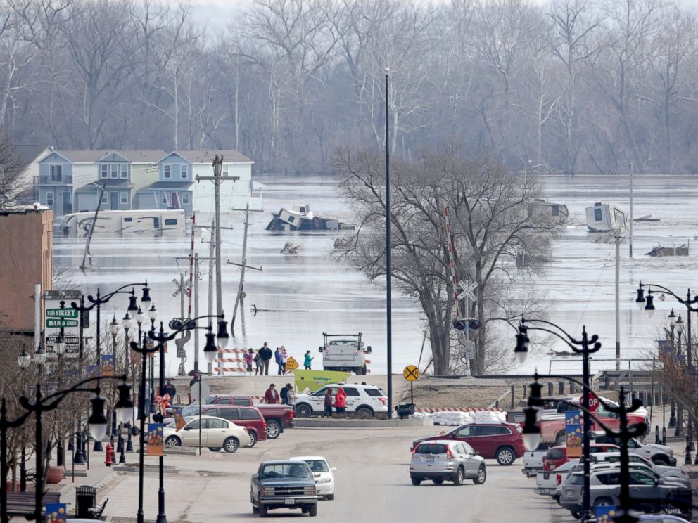 PHOTO: People view the rising waters from the Platte and Missouri rivers which flooded areas of Plattsmouth, Neb., Sunday, March 17, 2019.