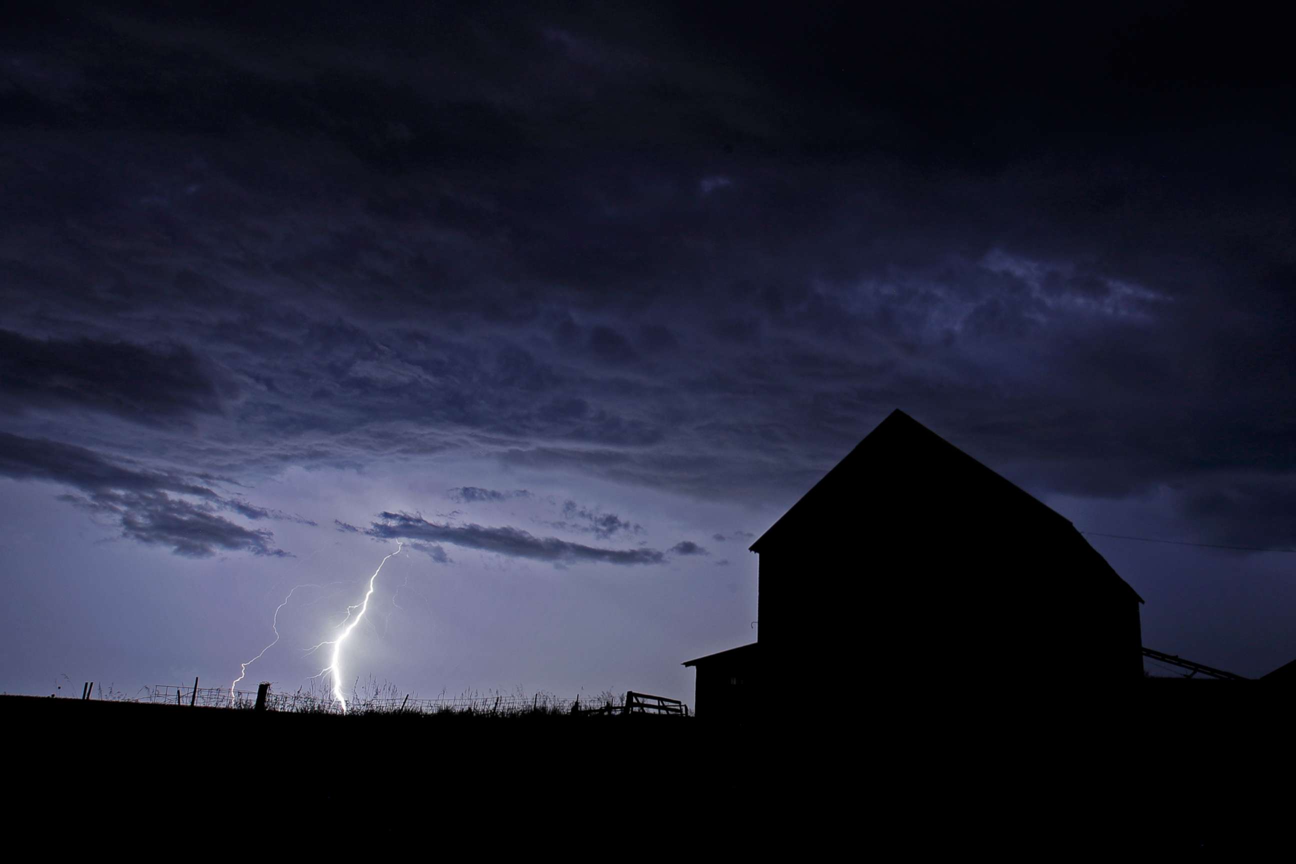 PHOTO: A barn is silhouetted against an approaching thunderstorm, Wednesday, July 31, 2019, near Tonganoxie, Kan.