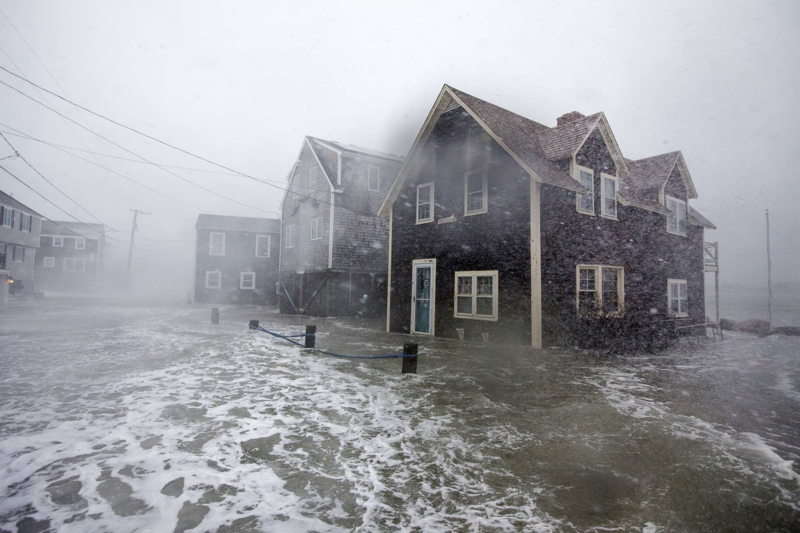 PHOTO: Lighthouse Rd. begins to flood during a large coastal storm  March 2, 2018 in Scituate, Mass.