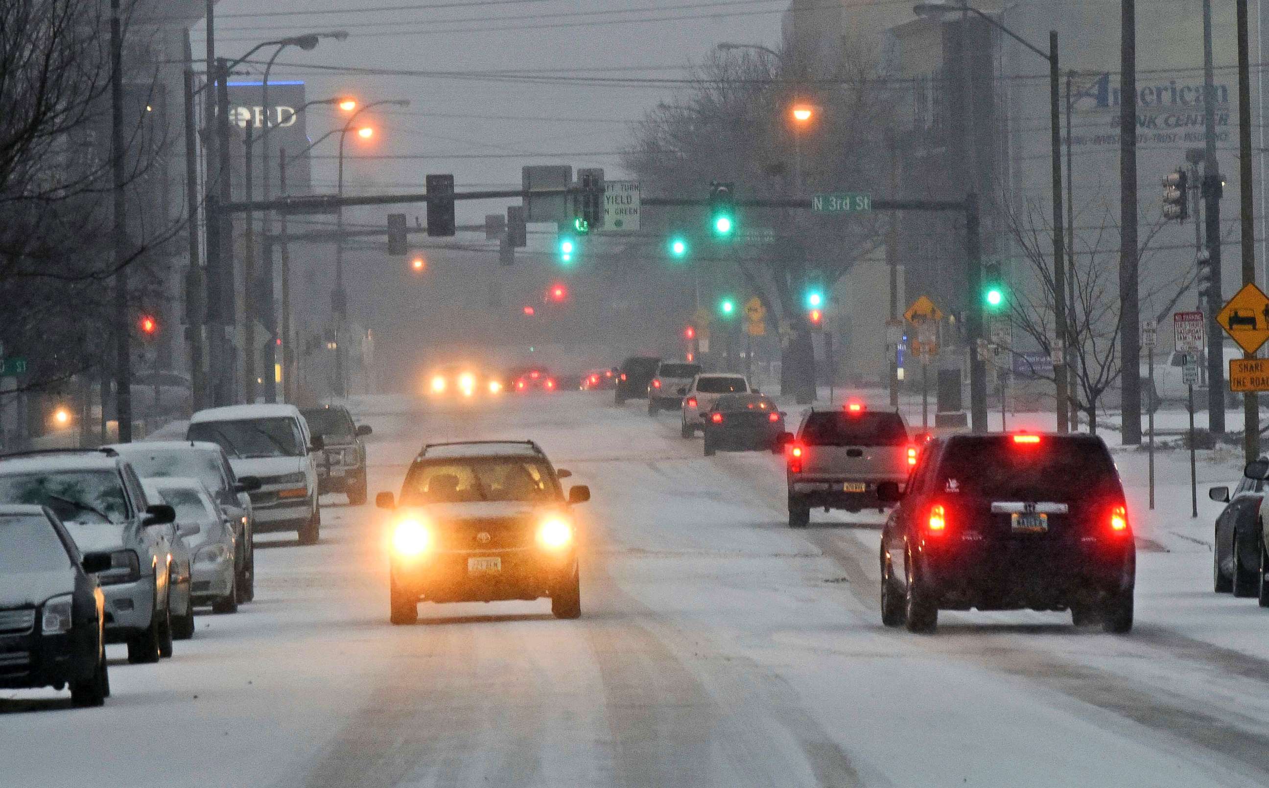 PHOTO: Traffic moves down a snow covered street in Bismarck, N.D., March 5, 2018, as snow falls.