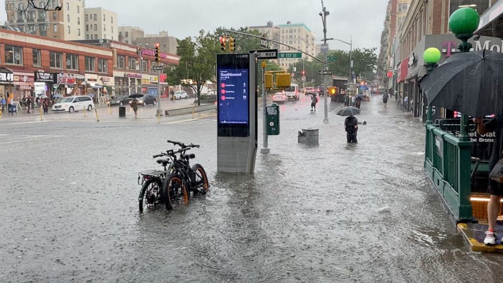 PHOTO: A person wades through the flood water near the 157th St. subway station in New York City, July 8, 2021.