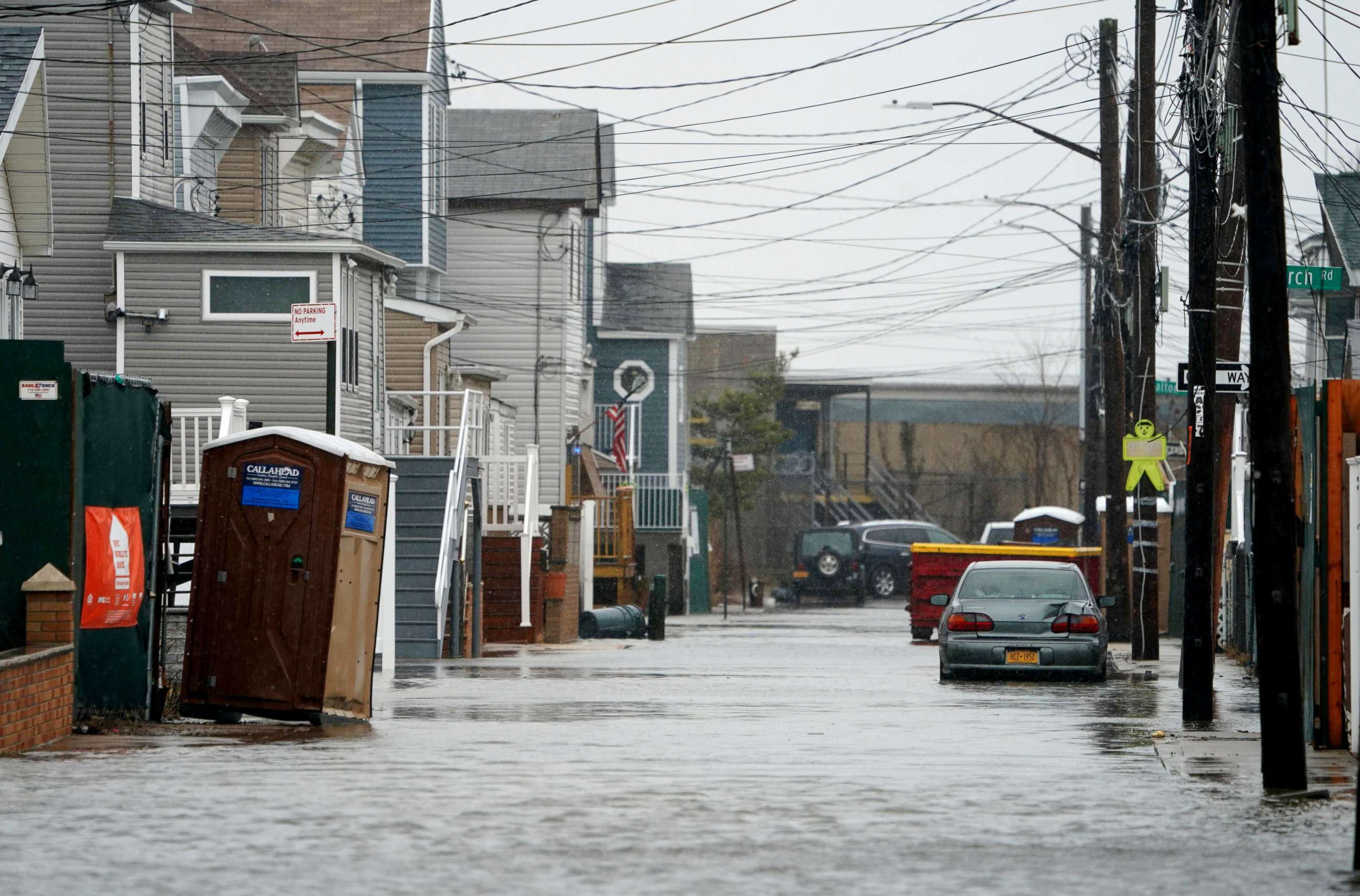 PHOTO: A car sits in high water on a flooded street during rain and high winds, March 2, 2018, in the Broad Channel section of Queens in New York.        