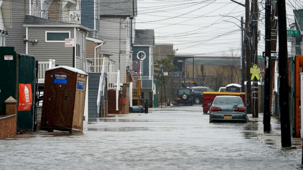 PHOTO: A car sits in high water on a flooded street during rain and high winds, March 2, 2018, in the Broad Channel section of Queens in New York.        