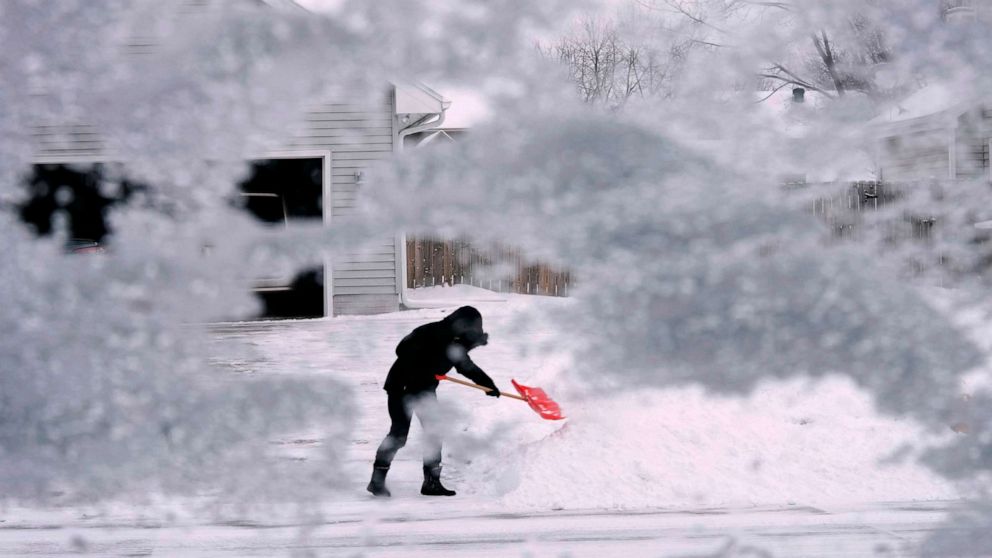 PHOTO: A local resident shovels snow off the end of a driveway, Dec. 22, 2022, in Urbandale, Iowa.