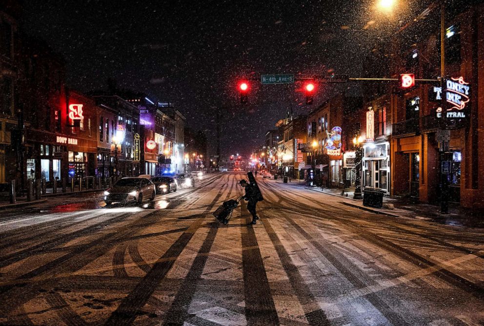 PHOTO: A musician departs following a show on Broadway, a popular tourist street in Nashville, Tennessee, Dec. 22, 2022.