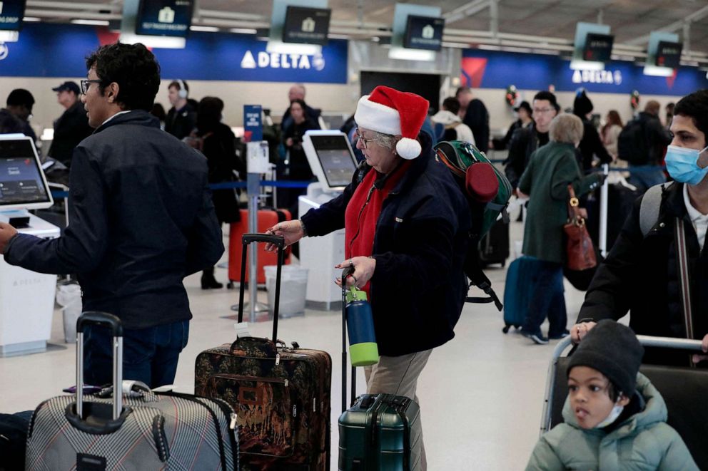 PHOTO: Passengers check in at the Delta counter at Detroit Metro Airport in Romulus, Michigan, on Dec. 22, 2022.