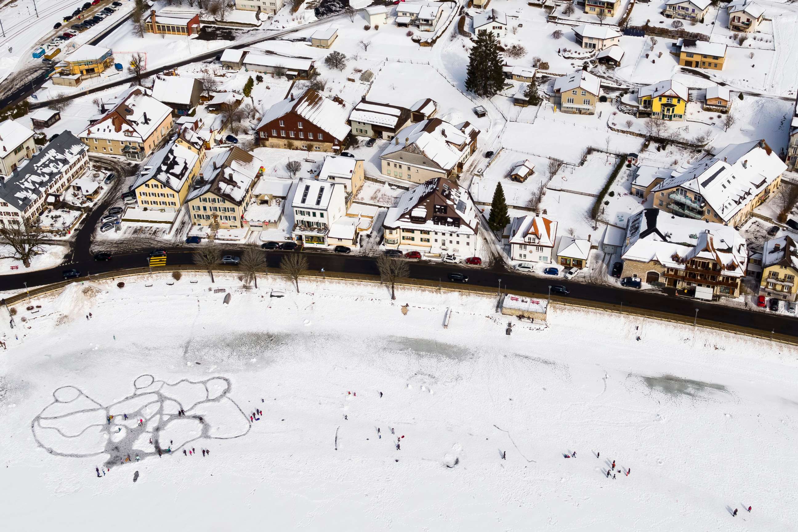 PHOTO: A picture taken with a drone shows people walking on ice paths carved through the snow on the frozen lake 'Lac de Joux' after a series of cold days in Le Pont, Western Switzerland, March 4, 2018.