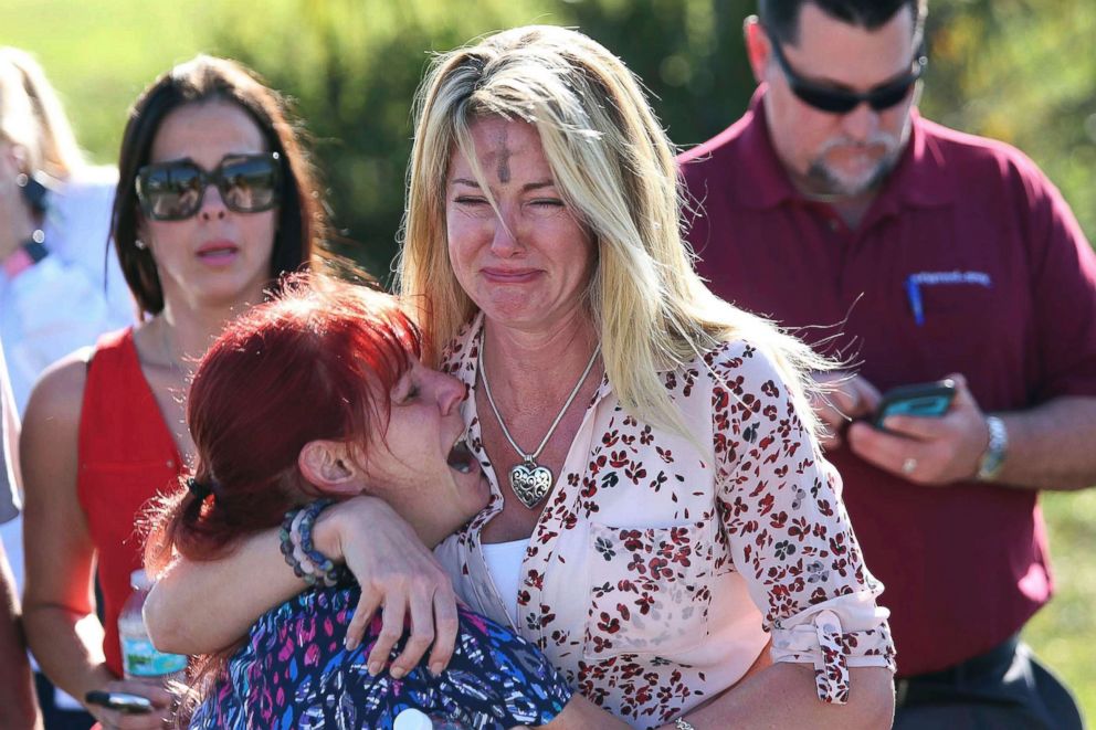 PHOTO: Women cry in an area where parents wait for news after reports of a shooting at Marjory Stoneman Douglas High School in Parkland, Fla., on Feb. 14, 2018. 