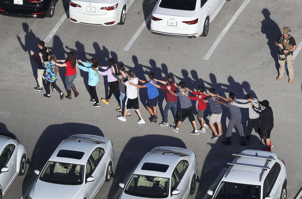 PHOTO: People are brought out of the Marjory Stoneman Douglas High School after a shooting at the school that reportedly killed and injured multiple people on Feb. 14, 2018, in Parkland, Fla.